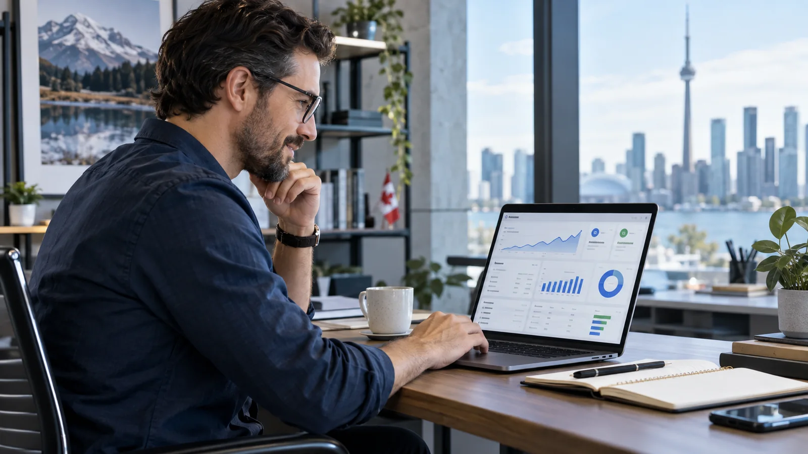 Small business owner reviewing advertising campaign performance on a laptop in a Toronto office.